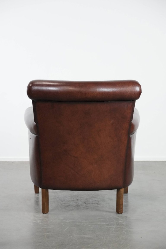 Image 1 of Donkere luxe schapenleren fauteuil/ armchair met een tijdloze uitstraling