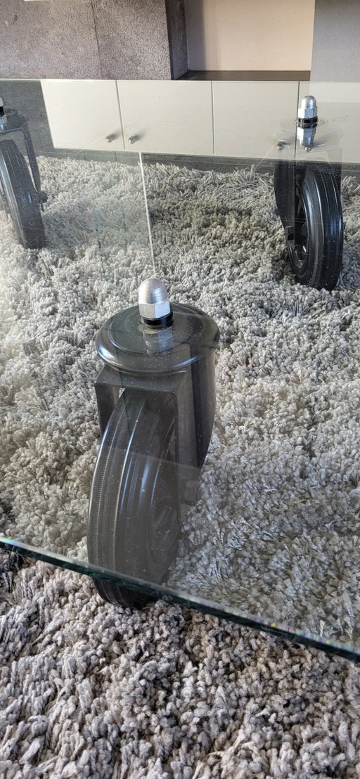 Glass coffee table with black wheels