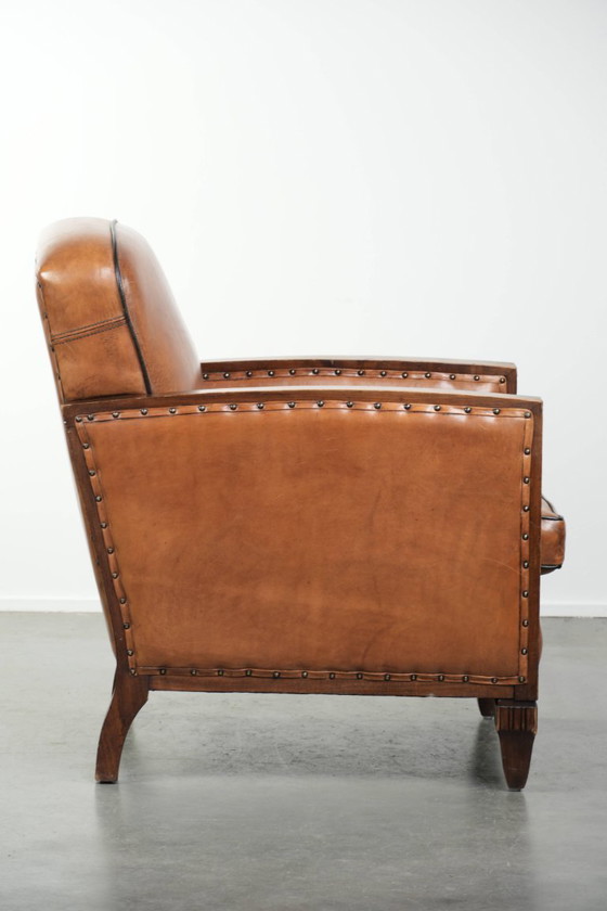 Image 1 of Unieke schapenleren art Deco fauteuil met mooi houtsnijwerk en zwarte biezen