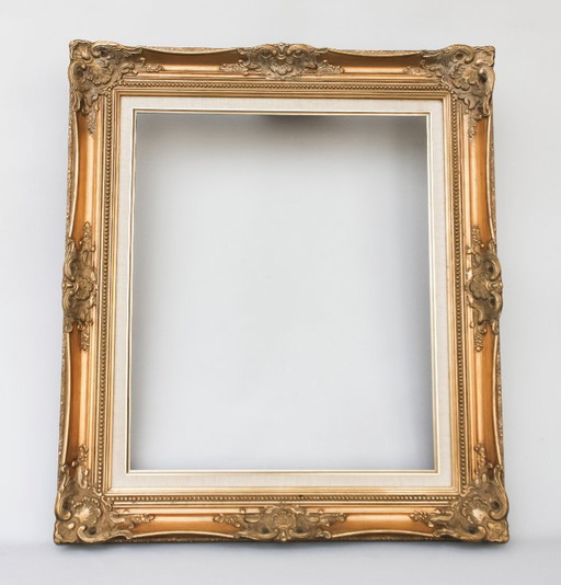 Antique Baroque wooden frame, patinated with gold leaf, handmade, Louis XVI style. Baroque frame for a painting, mirror, etc.