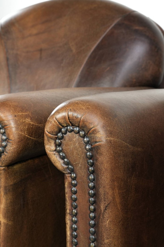 Image 1 of 2 fauteuils design en peau de mouton avec une belle patine