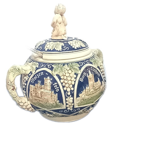 Old bowl with ladle. Castle motifs in relief.