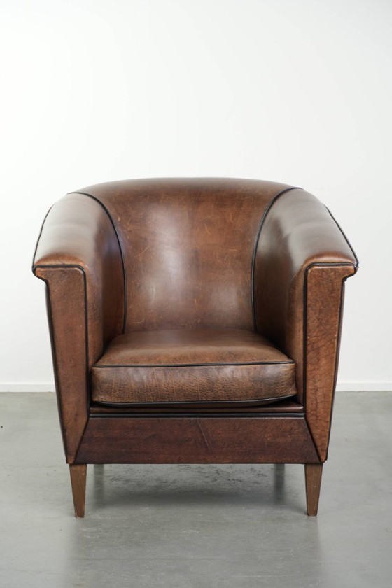 Image 1 of Elegante e raffinata poltrona club in pelle di pecora dal design Art Déco con profili neri.
