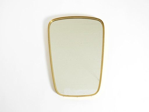 A pair of rare original Mid Century Modern "Münchener Zierspiegel" wall mirrors with heavy brass frames