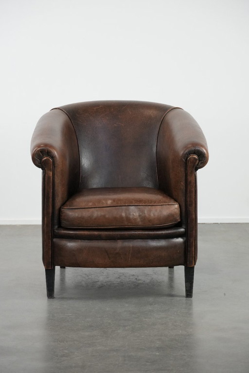 Sturdy and characterful vintage sheepskin club armchair