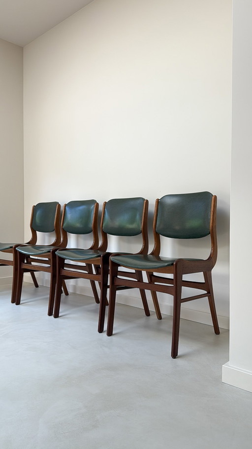 Four vintage wooden chairs with green faux leather