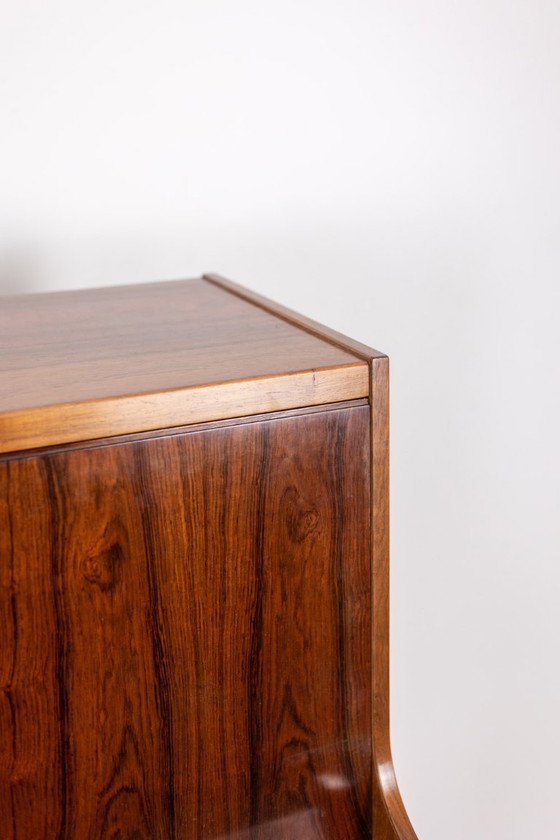 Image 1 of Commode van palissanderhout met 2 laden, die tevens als secretair dient. Jaren 70.