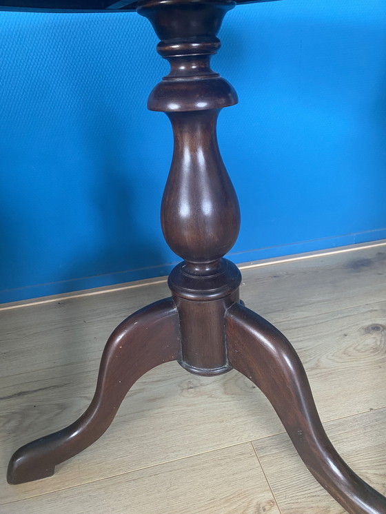 Image 1 of 1 Vintage round side/ wine table with leather top upholstery.