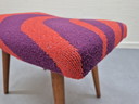 Vintage footstool with graphic print in orange/purple.