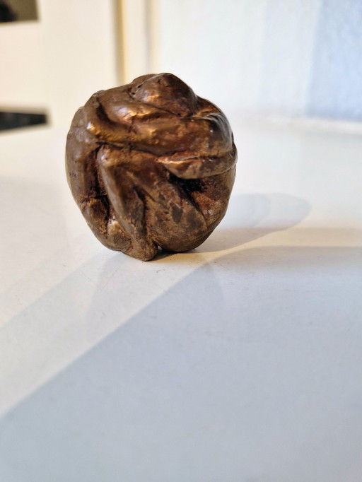 Solid small bronze statuette of two figures stamped into each other.