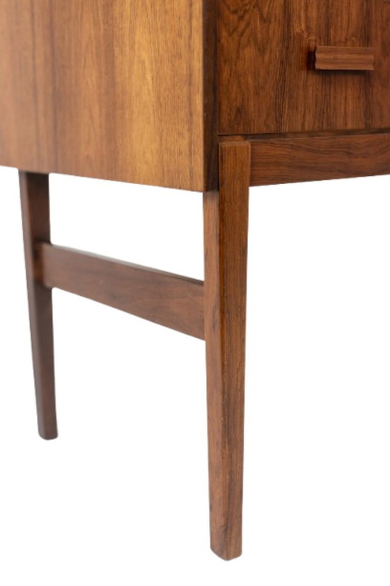 Image 1 of Commode van palissanderhout met 2 laden, die tevens als secretair dient. Jaren 70.