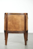 Antique armchair of sheepskin and wood with decorative nails and beautiful woodwork
