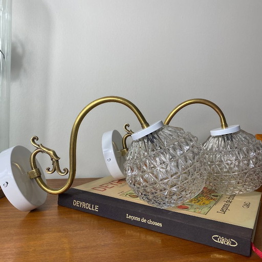 Large pair of brass gooseneck wall lights, clear glass globes, white metal rosettes