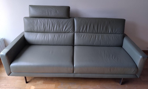 Prominent olive green two-seater sofa