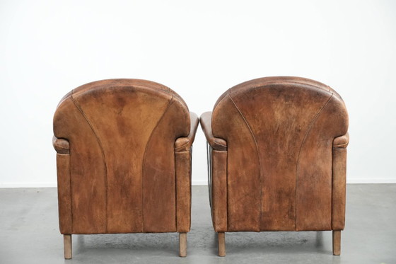 Image 1 of 2 x Vintage sheepskin armchair with warm colours and a characterful appearance