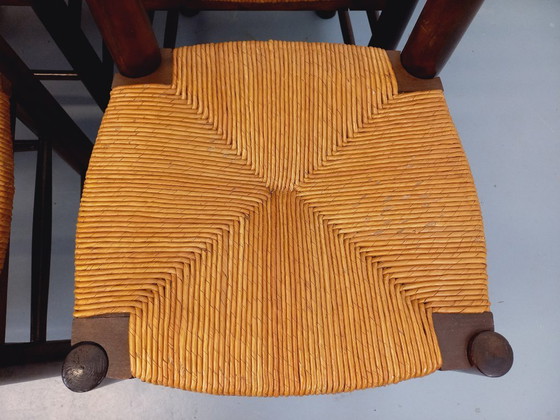 Image 1 of Set van 6 vintage brutalistische stoelen van Georges Robert, gemaakt van hout en stro, uit de jaren 50 en 60.