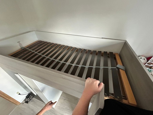 Loft bed with integrated wardrobe and desk
