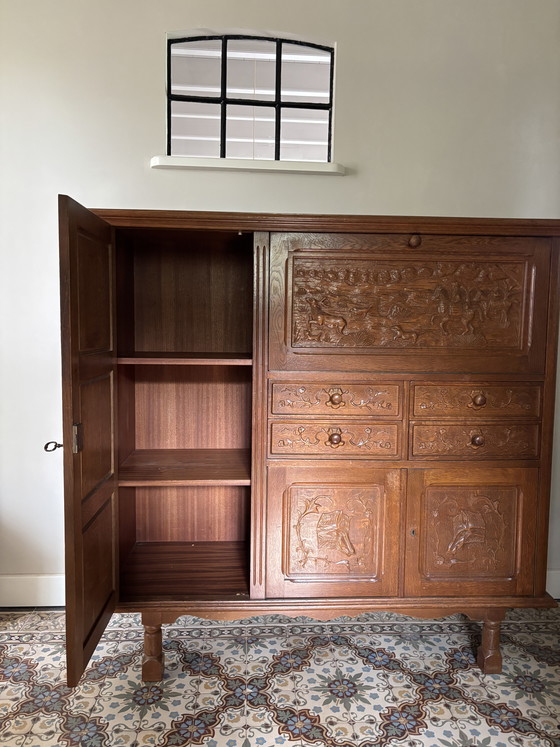 Image 1 of Antique oak secretary hunting cabinet with unique wood carving