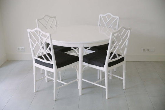 Image 1 of Dining room table and 4 chairs Jonathan Adler style. In 2024 the seats of the chairs are upholstered in black fabric.