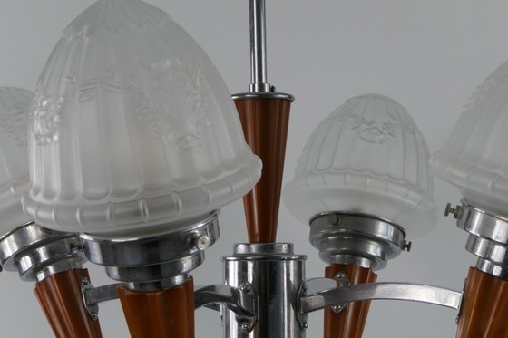 Image 1 of Chrome Art Deco chandelier with four amber Bakelite torches with decorated glass lampshades, ca. 1935
