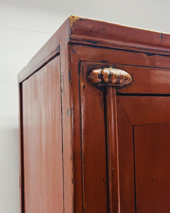 Image 1 of Antique red cabinet with brass details