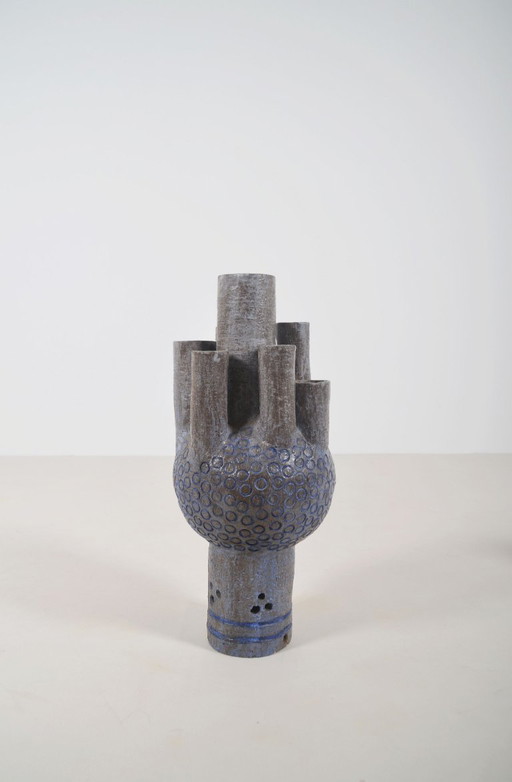 Ceramic sculpture with circular patterns and signature