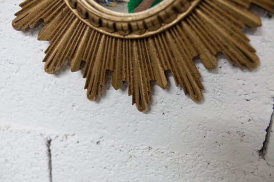 Image 1 of Vintage bolle spiegel uit de jaren 70 met heksenoogmotief en zonnestralenmotief.