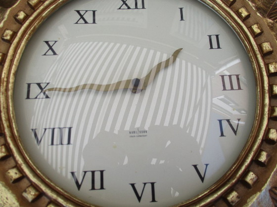 Image 1 of Karlsson Zonneklok vergulde 22k goud zware wandklok uit eind 20e eeuw werkt prima.