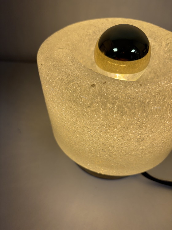 Image 1 of vintage table lamp by Peill & Putzler is made of thick ice glass with brass details
