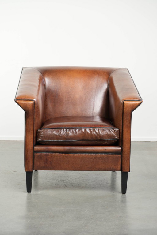 Sheepskin Art Deco design armchair with black piping