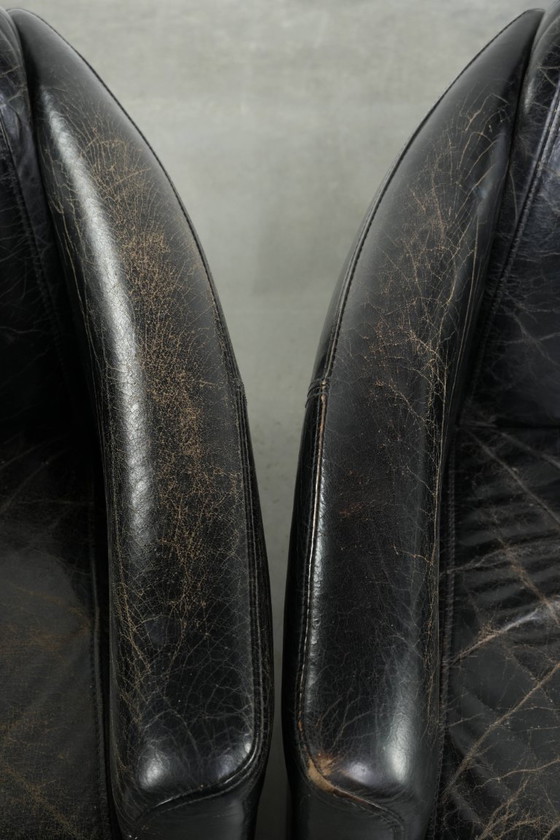 Image 1 of 2x rugged black vintage cowhide Aviator design armchairs with a distinctive look
