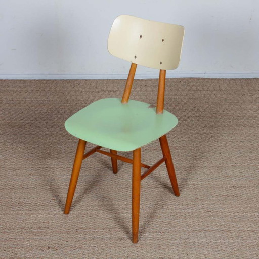 Green chair produced by Ton in the 1960s