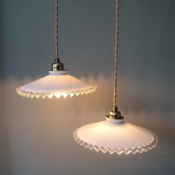 Image 1 of 2 vintage hanglampen van wit opaline glas met een transparante sierrand.