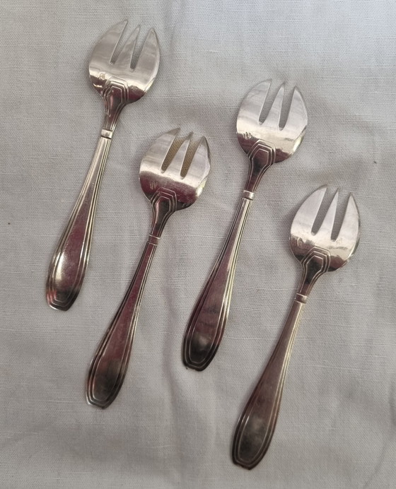 Image 1 of 4 fourchettes à huîtres argent massif minerve