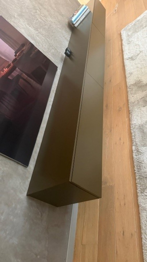brown wall cupboard (possibly for under TV) with 3 folding doors
