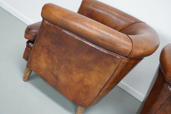 Image 1 of Vintage Nederlandse leren clubfauteuils in cognackleur, set van 2 met voetenbank