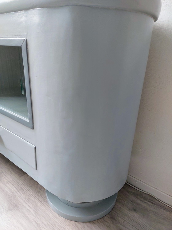 Image 1 of Sideboard with glass sliding doors and rounded shapes
