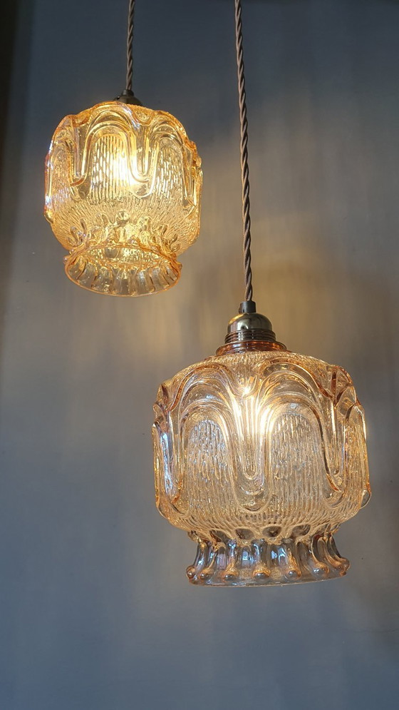 Image 1 of Set of 2 Vintage textured rose / amber tinted pendant lamps - mid-century design.