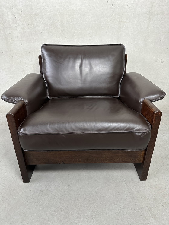 Image 1 of Vintage Leolux bruinkleurige lederen/eiken ‘Lounge chair and ottoman’ van Harry de Groot - 1970