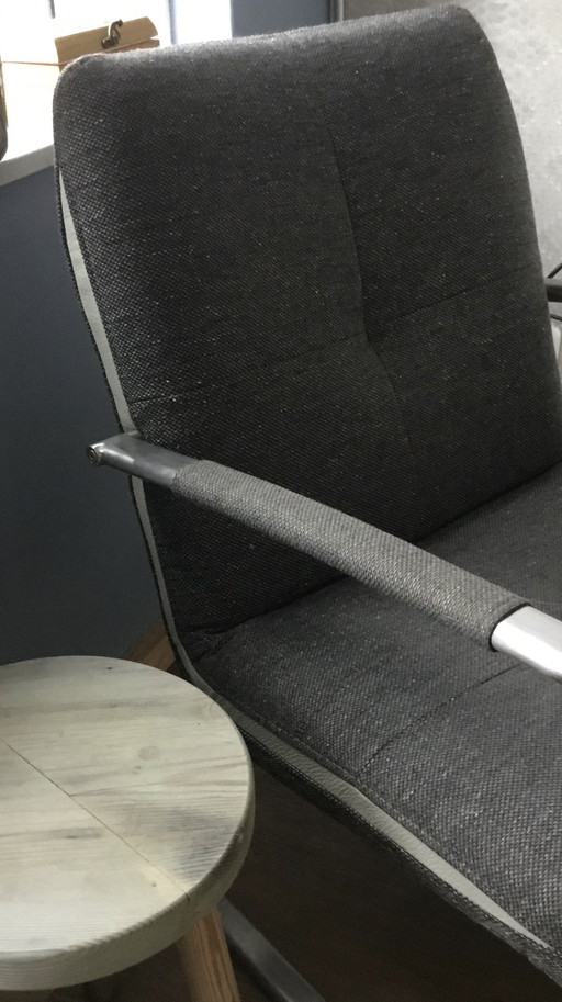 Brown armchair with cream leather accents by Henders and Hazel