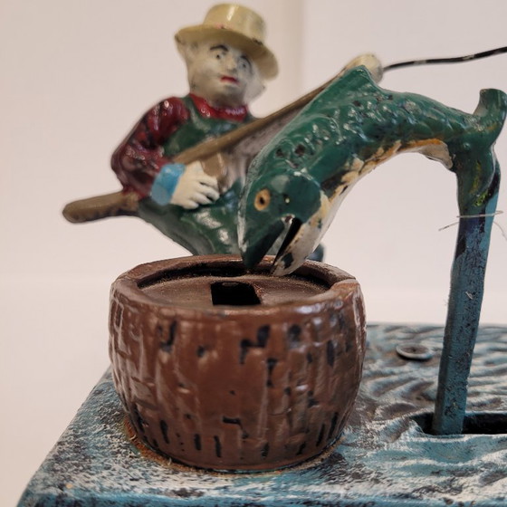 Image 1 of "Fisherman" piggy bank with fishing mechanism, cast iron, 1950s - USA.