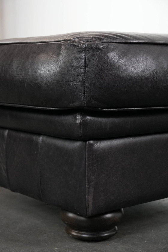 Image 1 of Set consisting of a black Chesterfield sofa, armchair and footstool made of cowhide