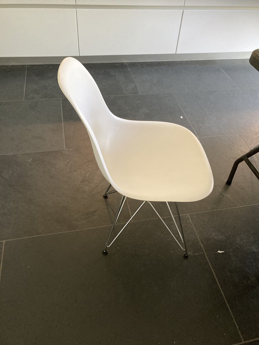 2 white Eames chairs