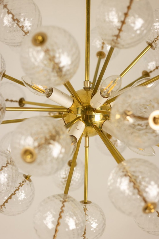 Image 1 of Kamenicky Senov, editor. Pair of brass and glass chandeliers. Circa 1970