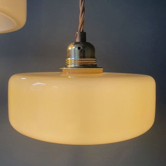 Image 1 of Vintage pendant lamp set (2) of yellow pastel opaline glass. Art Deco design.