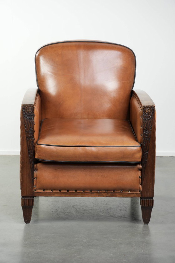 Image 1 of Unieke schapenleren art Deco fauteuil met mooi houtsnijwerk en zwarte biezen
