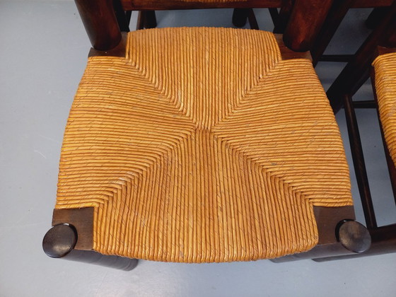 Image 1 of Set van 6 vintage brutalistische stoelen van Georges Robert, gemaakt van hout en stro, uit de jaren 50 en 60.
