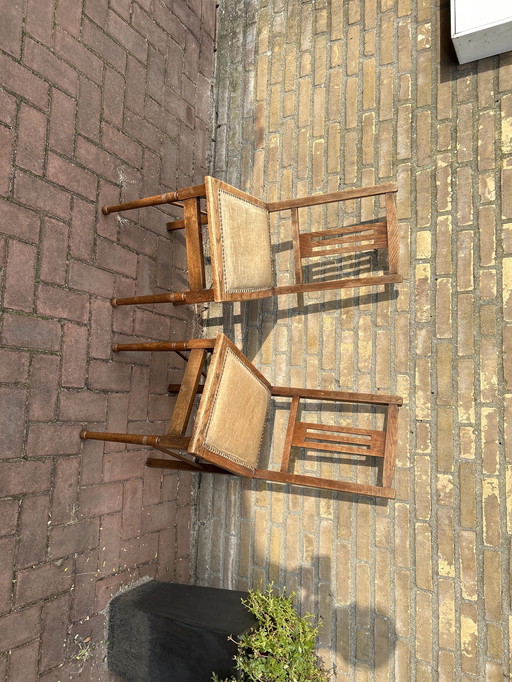 Dining room chairs with fabric seats and nail trim.
