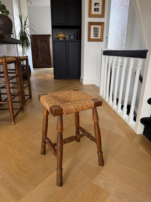 Vintage wooden stool with wicker seat