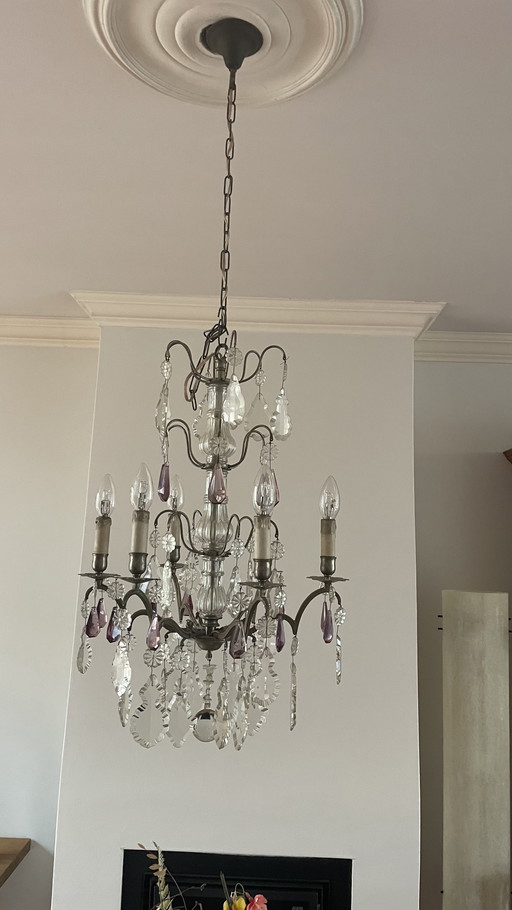 Elegant antique French chandelier with colored pendants